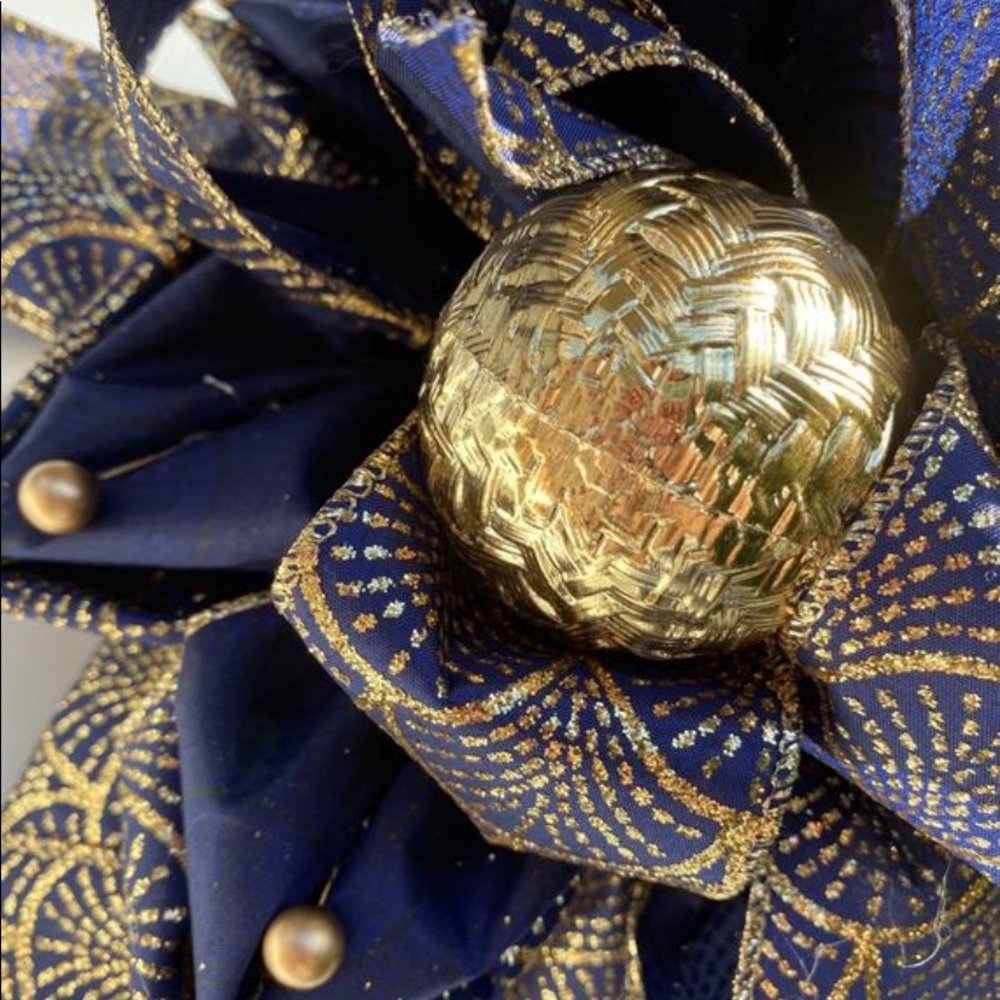 Traditional round blue and gold ribbon wreath